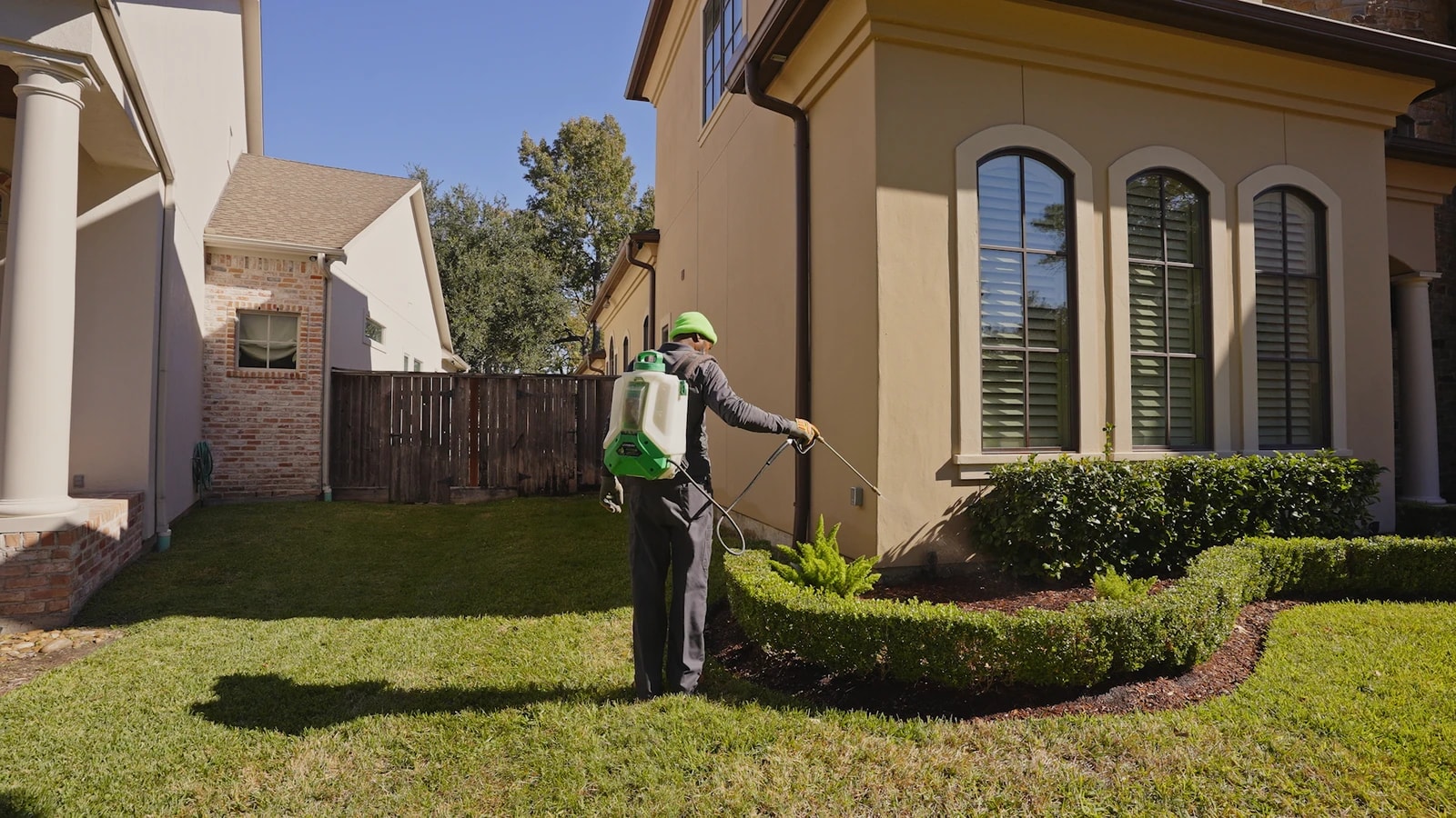 An Acenitec technician treating the foundation line of a home