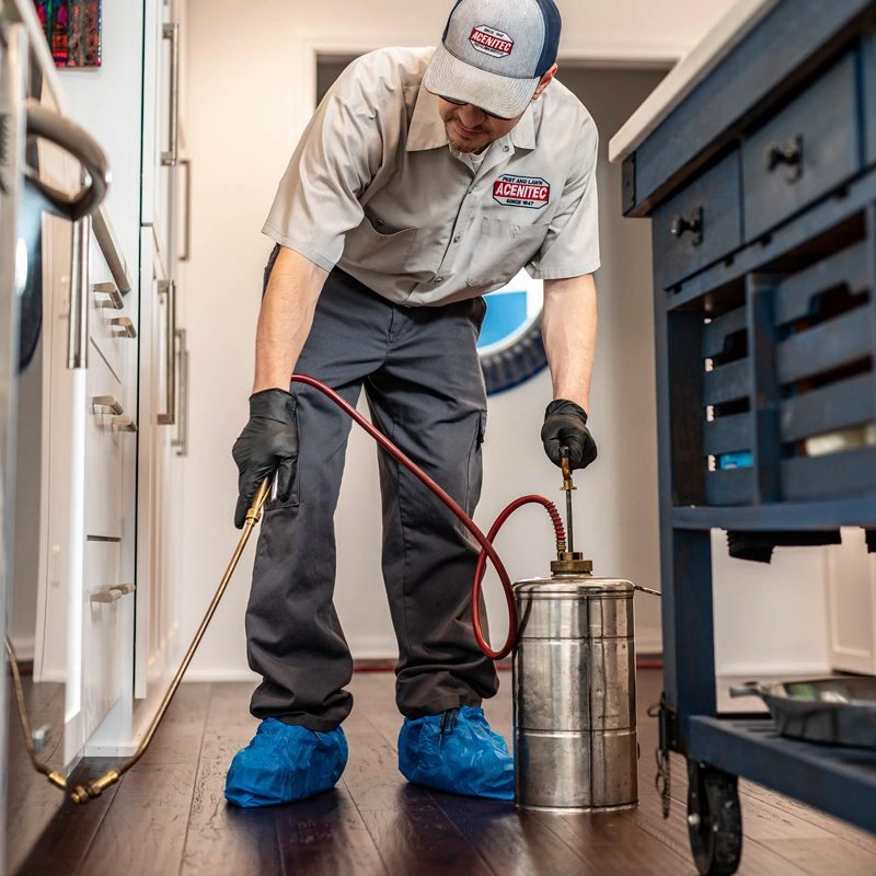 An Acenitec technician applying an interior treatment, shoe covers on