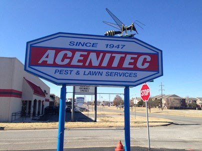 The Acenitec Pest & Lawn Services monument sign with the giant mosquito sculpture on top, Since 1947